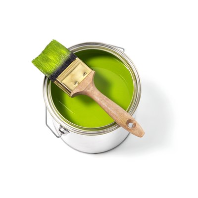 Green paint tin can with brush on top