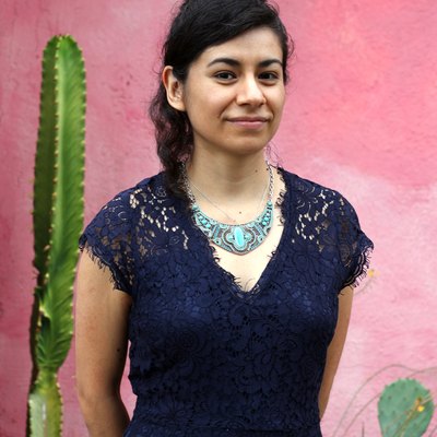 person standing near pink wall and cactus