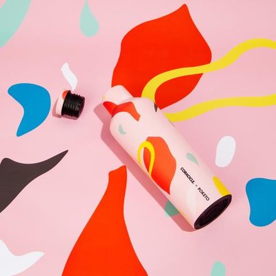 multi-colored water bottle with pink background