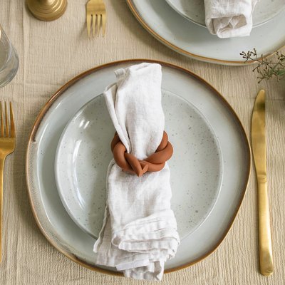 Plate setting with linen napkin inside a DIY twisted clay napkin ring