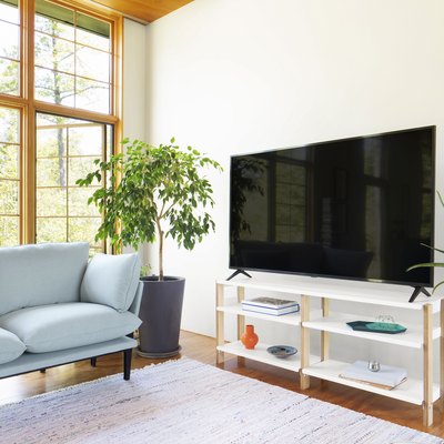 living room with blue couch and media console