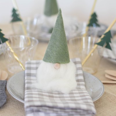 Christmas table decorated with Santa gnomes and mitten utensil holders