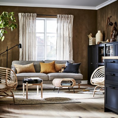 living room with natural materials and dark brown walls