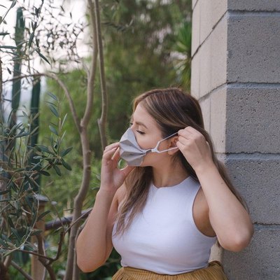 woman putting on mask