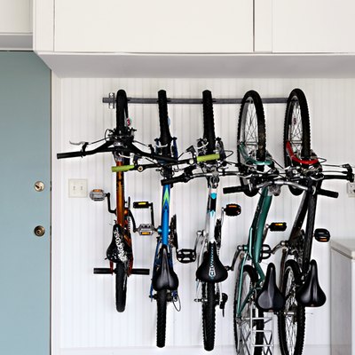 Bike storage using a rack in the garage next to blue door
