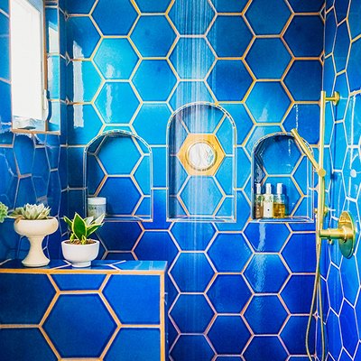 hexagon shaped blue shower tile in bohemian bathroom