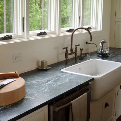 gray soapstone countertops and farmhouse sink with gooseneck bridge faucet