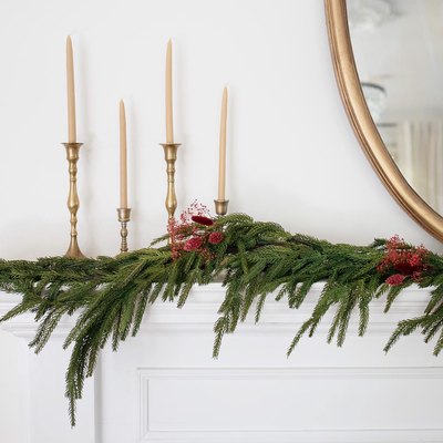 Holiday mantel garland decorated with berry-colored dried floral sprays