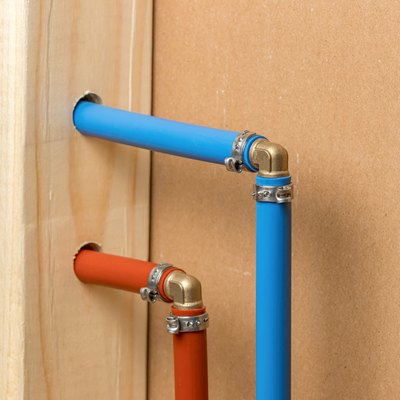 Pex plastic water supply plumbing pipe in wall of house. Concept of home repair, maintenance and remodeling