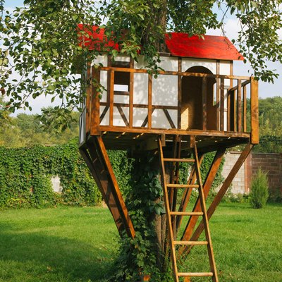 Cute small tree house for kids on backyard.