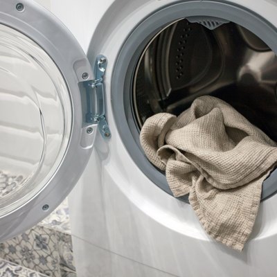 Towel hanging out of a washing machine