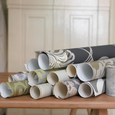 Rolls of wallpaper on decorating table.