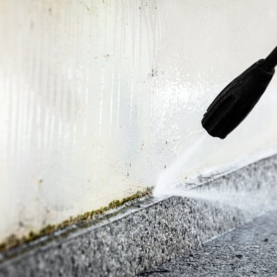 Cleaning a concrete wall.