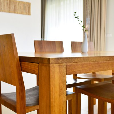 Natural oak wood dining table and chairs in modern interior design house