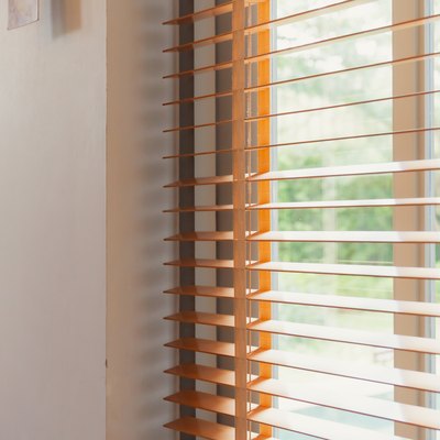 Window blind letting in light from sun, home interior concept