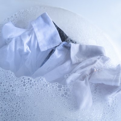 White shirt soaking in water with detergent.