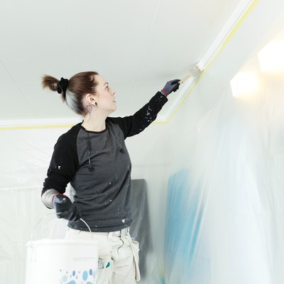 Painting a ceiling.