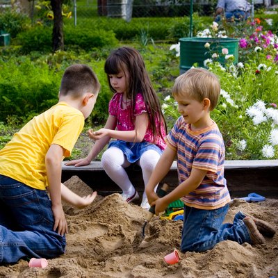 Kids playing in sandbox.