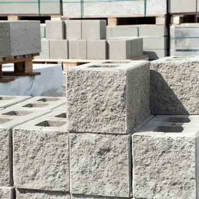 Stack of cement concrete Building cinder blocks brick  on pallete in hardware store with decorative stone texture side