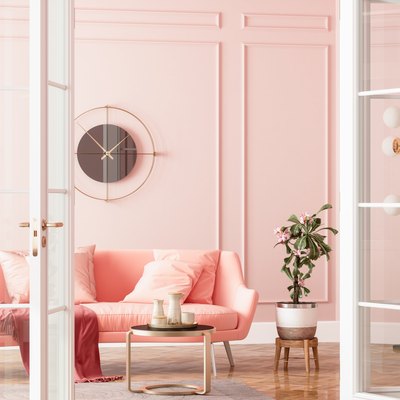Entrance Of Living Room With Wall Clock, Pink Sofa, Potted Plant And Coffee Table
