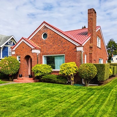 Small Red Brick House With Green Grass