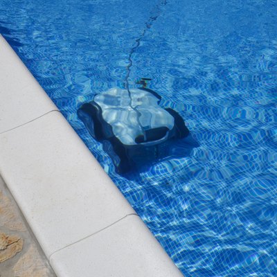 Cleaning the pool floor with an underwater vacuum cleaner, pool maintenance concept.