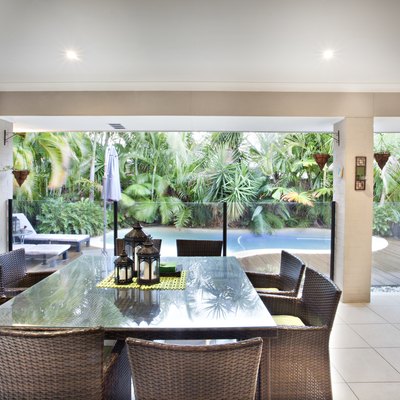 Outdoor dining glass table near swimming pool.