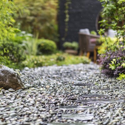Decorative sprinkling of flowerbed paths with pebbles