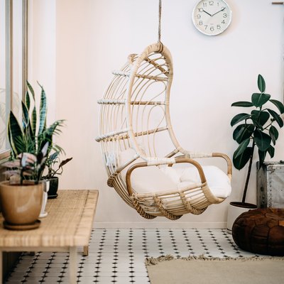 Cozy hanging chair in loft living room with stylish boho design.