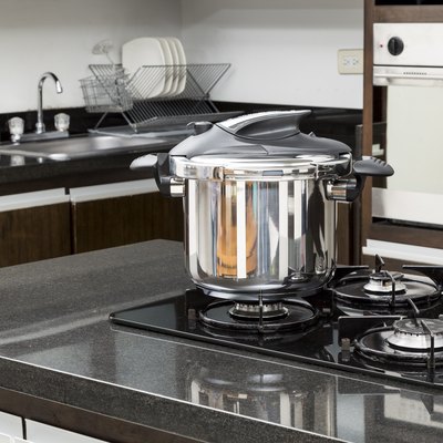 Household appliances - pressure cooker in a kitchen setting.