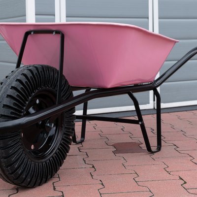 New pink garden wheelbarrow on patio.