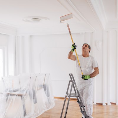 Man painting a ceiling.