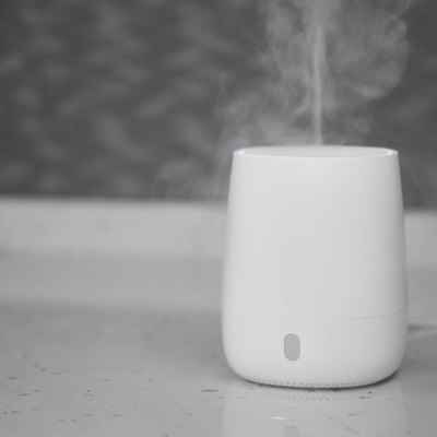 Air humidifier stands on tabletop surface