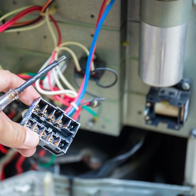 Close up of Air Conditioning Repair, repairman test, checking & repair of magnetic contactor and fixing air conditioning system