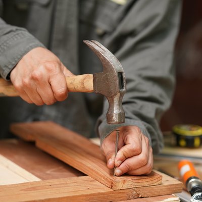 Carpenters uses a hammer to driving nail