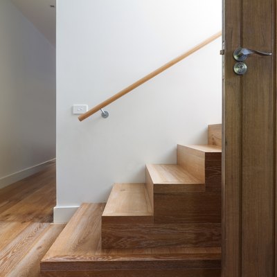 Modern staircase of oak wood beside front door horizontal