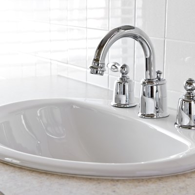 Closeup of bathroom vanity with white sink.