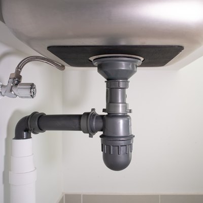 Water drain pipe under kitchen sink.