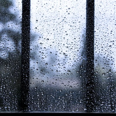 Raindrops on window pane on a cold day of winter
