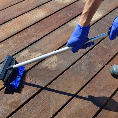 Cleaning Deck With Blue Gloves And Brush