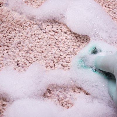 Hand washing pink carpeting.