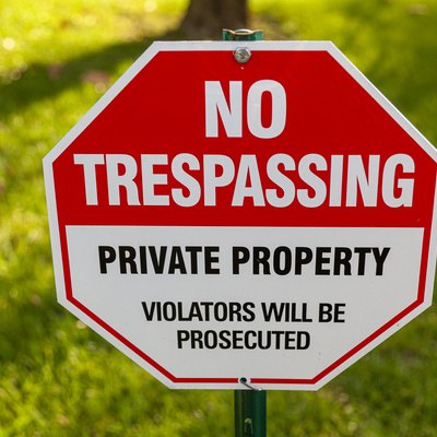 "Private Property, No Trespassing, Violators will be prosecuted" yard sign