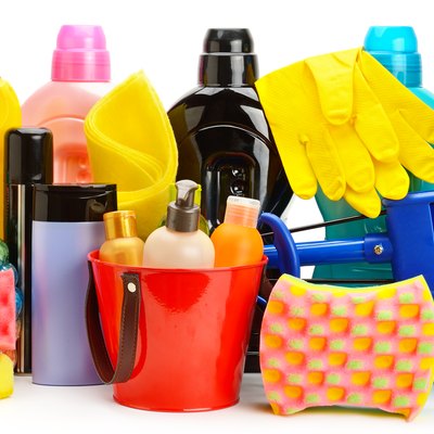 Collection of various household cleaning products isolated on a white background.