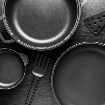 Black cookware with a nonstick coating on black background