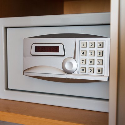 Electronic safe on shelf in cabinet
