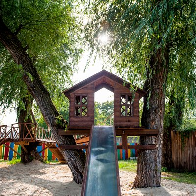 tree house with a slide on the playground