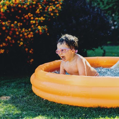 little boy having fun in inflatable pool