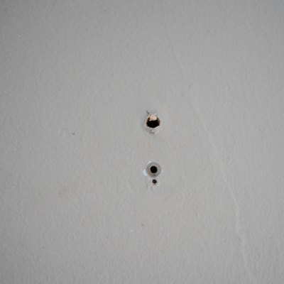 Small drill holes in a wall