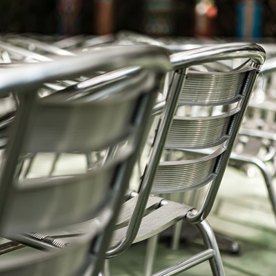 Aluminum  chairs and tables in outdoor cafe.