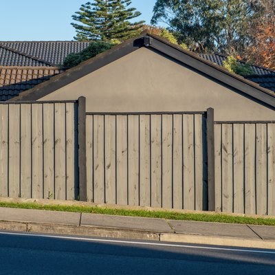 Slanted street with fence and house behind it in Australia